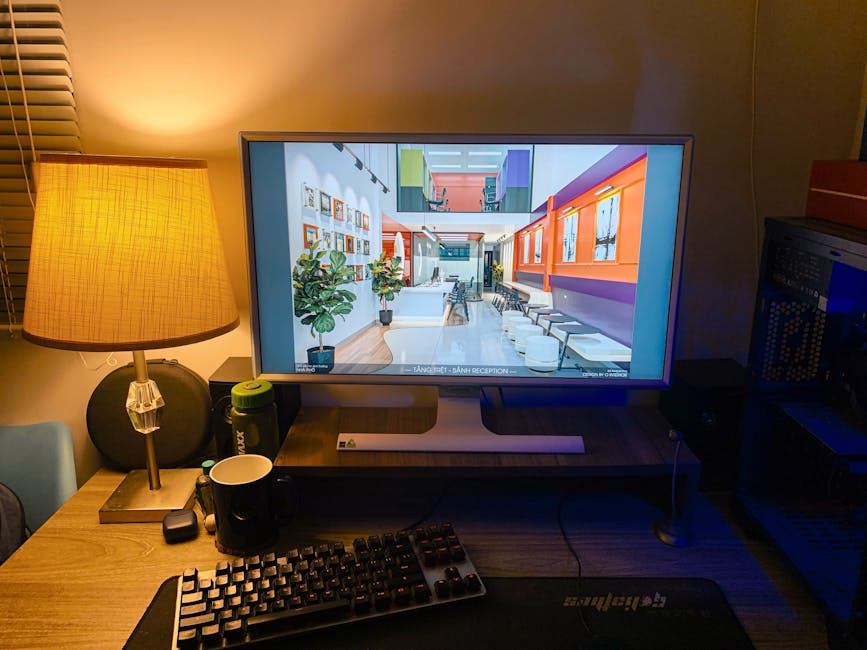 Warm and cozy home office setup with a computer, keyboard, and lamp lighting.